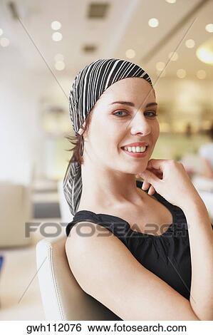 Stock Photograph - Portrait of a young woman smiling. Fotosearch