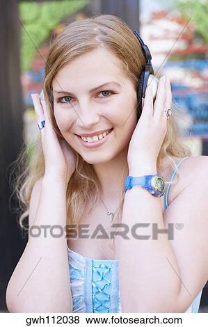 Portrait of a young woman wearing headphones View Large Photo Image Stock Photo - Portrait of a young woman wearing headphones. Fotosearch