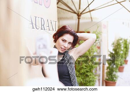 Picture - Young woman posing for a photograph . Fotosearch