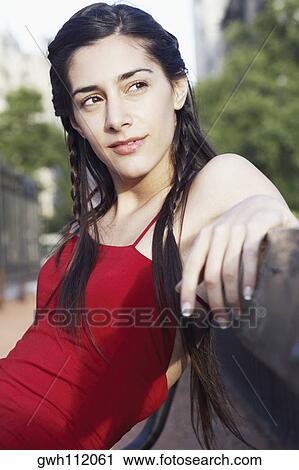 Young woman sitting on a bench View Large Photo Image Stock Image - Young woman sitting on a bench . Fotosearch