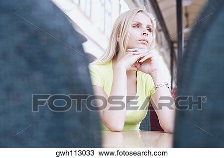 Stock Image - Low angle view of a young woman in a restaurant . Fotosearch
