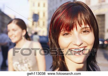 Stock Photo - Portrait of a young woman laughing . Fotosearch