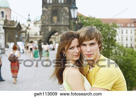 Side profile of a young man embracing a young woman View Large Photo Image Stock Photo - Side profile of a young man embracing a young woman . Fotosearch