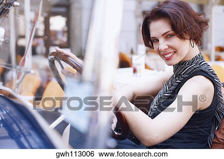 Side profile of a young woman in a car View Large Photo Image Stock Photograph - Side profile of a young woman in a car . Fotosearch