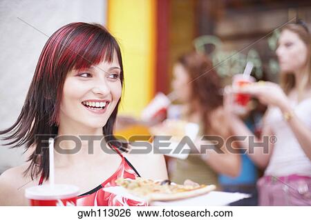 Young woman holding a plate with a cold drink and a slice of pizza View Large Photo Image Stock Photograph - Young woman holding a plate with a cold drink and a slice of pizza . Fotosearch
