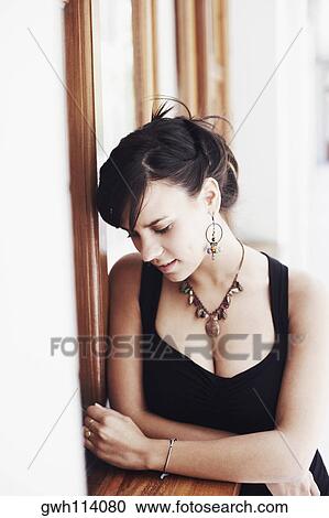 Close-up of a young woman with her arms crossed View Large Photo Image Stock Image - Close-up of a young woman with her arms crossed. Fotosearch
