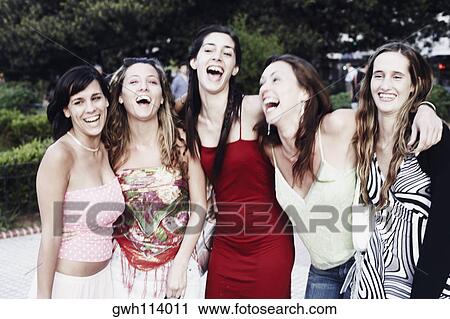 Five young women standing with their arms around each other and laughing View Large Photo Image Stock Image - Five young women standing with their arms around each other and laughing . Fotosearch