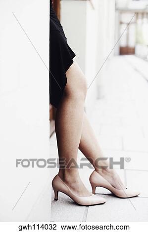 Low section view of a woman standing in the balcony View Large Photo Image Stock Image - Low section view of a woman standing in the balcony . Fotosearch