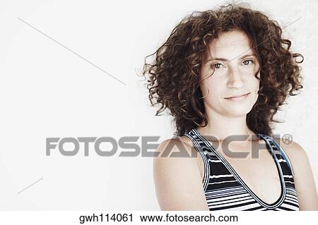 Stock Image - Portrait of a mid adult woman smirking. Fotosearch