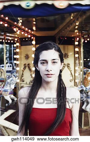 Portrait of a young woman standing in an amusement park View Large Photo Image Stock Photo - Portrait of a young woman standing in an amusement park . Fotosearch