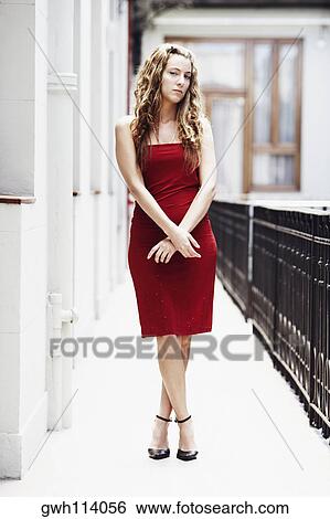 Portrait of a young woman standing in the balcony View Large Photo Image Stock Photograph - Portrait of a young woman standing in the balcony . Fotosearch