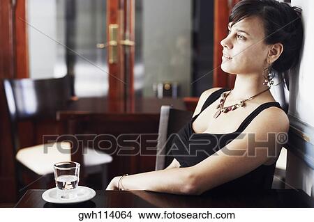 Side profile of a young woman leaning against a wall and thinking View Large Photo Image Picture - Side profile of a young woman leaning against a wall and thinking. Fotosearch