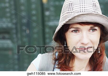 Close-up of a young woman looking away View Large Photo Image Stock Photography - Close-up of a young woman looking away. Fotosearch