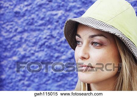 Stock Photography - Close-up of a young woman wearing a hat. Fotosearch