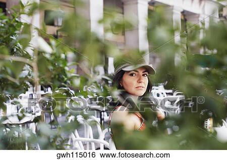 Portrait of a mid adult woman sitting in a restaurant View Large Photo Image Stock Photograph - Portrait of a mid adult woman sitting in a restaurant . Fotosearch