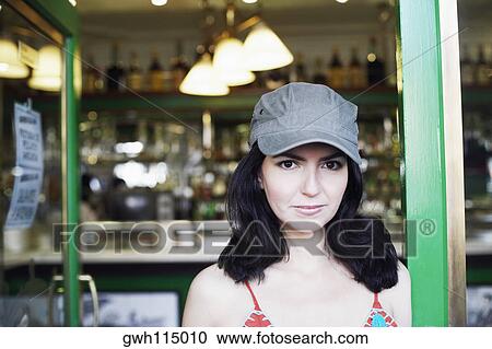 Stock Image - Portrait of a mid adult woman smirking. Fotosearch