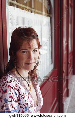 Portrait of a young woman leaning against a wall View Large Photo Image Stock Photography - Portrait of a young woman leaning against a wall . Fotosearch
