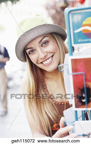 Portrait of a young woman looking at postcards View Large Photo Image Stock Image - Portrait of a young woman looking at postcards. Fotosearch