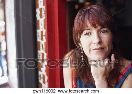 Portrait of a young woman with her hand on her chin View Large Photo Image Stock Image - Portrait of a young woman with her hand on her chin. Fotosearch