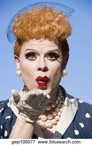 Close-up of a gay man blowing a kiss in a costume View Large Photo Image Stock Photo - Close-up of a gay man blowing a kiss in a costume . Fotosearch
