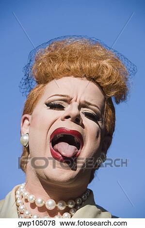 Close-up of a gay man in a costume sticking his tongue out View Large Photo Image Stock Photo - Close-up of a gay man in a costume sticking his tongue out. Fotosearch