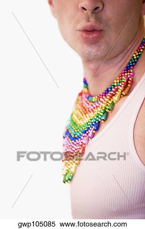 Close-up of a gay man wearing a colorful necklaces and puckering his lips View Large Photo Image Stock Photography - Close-up of a gay man wearing a colorful necklaces and puckering his lips. Fotosearch