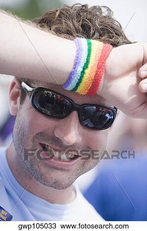 Stock Image - Close-up of a mid adult man with his hand on his forehead. Fotosearch
