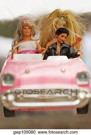 Close-up of three dolls in a toy car View Large Photo Image Stock Image - Close-up of three dolls in a toy car. Fotosearch