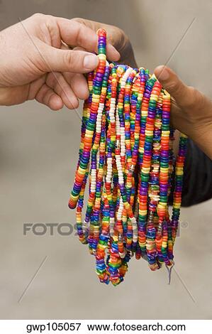Close-up of two people's hands holding necklaces View Large Photo Image Stock Photo - Close-up of two people's hands holding necklaces. Fotosearch