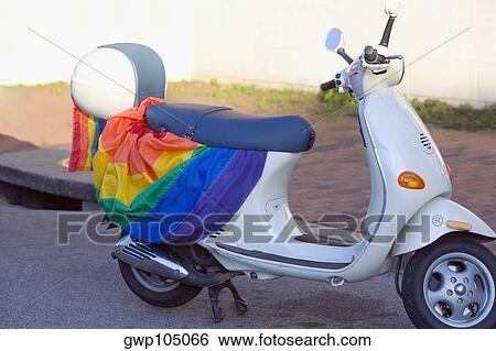 Gay pride flag on a moped parked on a path View Large Photo Image Stock Photograph - Gay pride flag on a moped parked on a path. Fotosearch