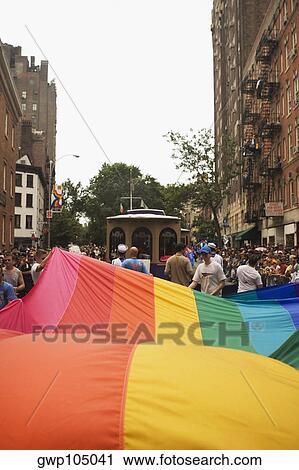 Group of people pulling a giant gay pride flag at a gay parade View Large Photo Image Stock Image - Group of people pulling a giant gay pride flag at a gay parade. Fotosearch