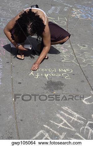 High angle view of a gay man writing a message with a chalk on the road View Large Photo Image Picture - High angle view of a gay man writing a message with a chalk on the road. Fotosearch