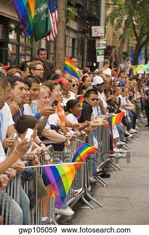 Large group of people holding gay pride flags and standing by a railing View Large Photo Image Stock Photo - Large group of people holding gay pride flags and standing by a railing. Fotosearch