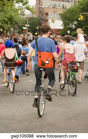 Stock Photo - Large group of people on bicycles at a gay parade. Fotosearch
