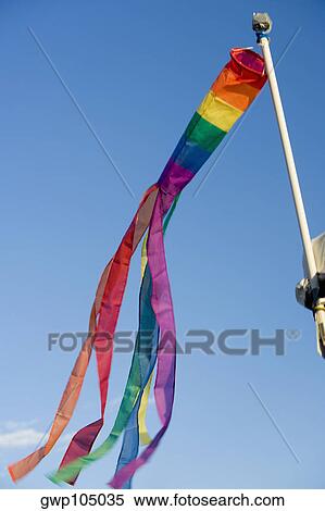 Low angle view of gay pride flag fluttering on a pole View Large Photo Image Stock Photography - Low angle view of gay pride flag fluttering on a pole. Fotosearch