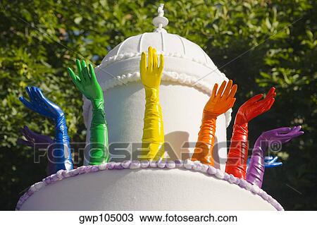 Stock Image - Low angle view of sculptures of human hands around a dome. Fotosearch