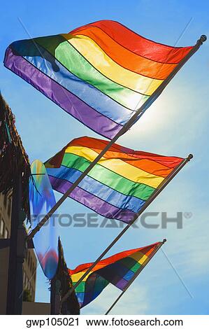 Low angle view of three gay pride flags fluttering on a building View Large Photo Image Stock Image - Low angle view of three gay pride flags fluttering on a building. Fotosearch