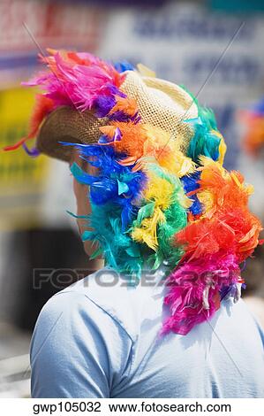 Rear view of a man wearing colorful feather on a sunhat View Large Photo Image Stock Image - Rear view of a man wearing colorful feather on a sunhat. Fotosearch