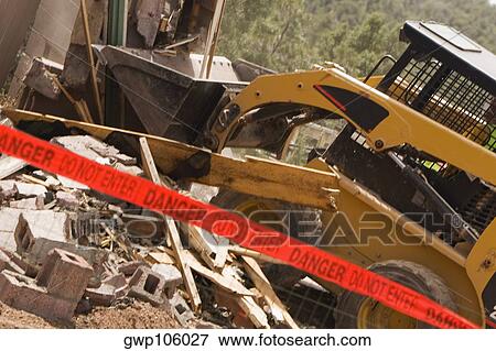 Bulldozer breaking down a building View Large Photo Image Stock Photo - Bulldozer breaking down a building. Fotosearch