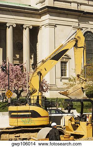 Bulldozer in front of a building View Large Photo Image Picture - Bulldozer in front of a building. Fotosearch