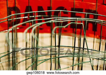 Close-up of a danger sign behind a metal structure View Large Photo Image Stock Photo - Close-up of a danger sign behind a metal structure. Fotosearch