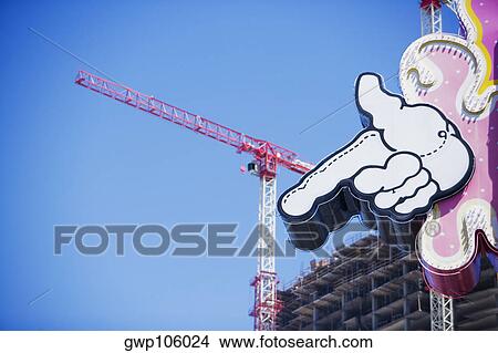 Close-up of an information board with a crane in the background at a construction site View Large Photo Image Picture - Close-up of an information board with a crane in the background at a construction site. Fotosearch