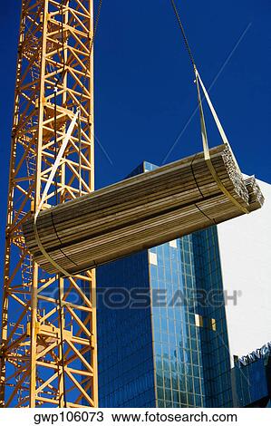 Low angle view of a crane picking up a bundle of wooden planks, Miami, Florida, USA View Large Photo Image Stock Image - Low angle view of a crane picking up a bundle of wooden planks, Miami, Florida, USA. Fotosearch
