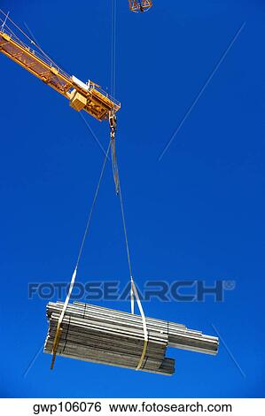 Low angle view of a crane picking up a bundle of wooden planks, Miami, Florida, USA View Large Photo Image Stock Photograph - Low angle view of a crane picking up a bundle of wooden planks, Miami, Florida, USA. Fotosearch