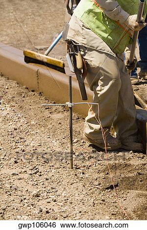 Side profile of construction workers working at a construction site View Large Photo Image Stock Photograph - Side profile of construction workers working at a construction site. Fotosearch