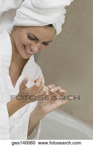 Close-up of a young woman filing her fingernails View Large Photo Image Stock Image - Close-up of a young woman filing her fingernails. Fotosearch