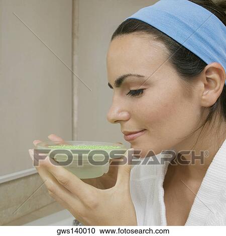 Close-up of a young woman smelling a dish of bath crystals View Large Photo Image Stock Image - Close-up of a young woman smelling a dish of bath crystals. Fotosearch