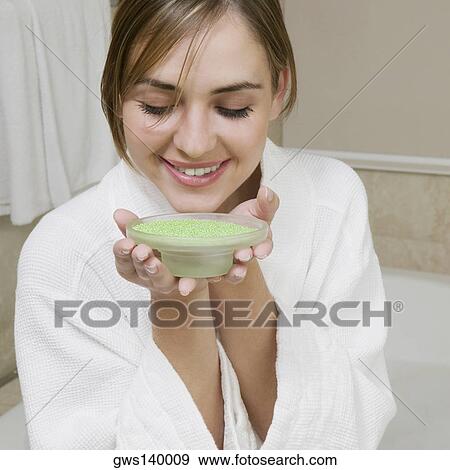 Close-up of a young woman smelling a dish of bath crystals View Large Photo Image Stock Photo - Close-up of a young woman smelling a dish of bath crystals. Fotosearch