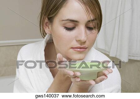 Close-up of a young woman smelling a dish of bath crystals View Large Photo Image Stock Photo - Close-up of a young woman smelling a dish of bath crystals. Fotosearch