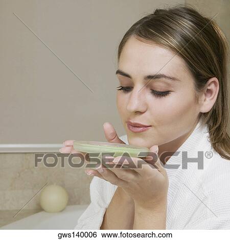 Close-up of a young woman smelling a dish of bath crystals View Large Photo Image Stock Photograph - Close-up of a young woman smelling a dish of bath crystals. Fotosearch